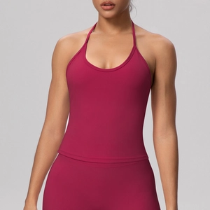 Close-up of vibrant magenta halter neck yoga vest with elastic straps and cross back detail