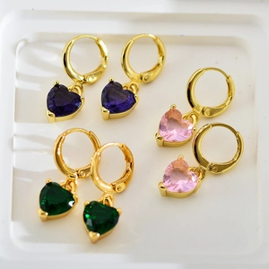 Detailed view of gold hoop earrings with purple, pink and green zircon heart charms