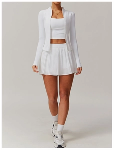 Detail of white 3-piece sports set featuring zip-up jacket and pleated tennis skirt