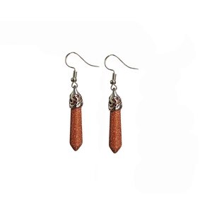 Detail of orange hexagon crystal column earrings with silver hollow flower caps