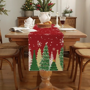 Red Christmas table runner with festive tree prints on a wooden dining table