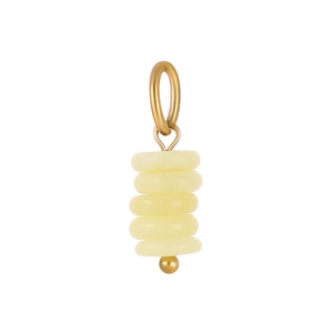 Macro shot of tiered pale yellow turquoise stones on a gold ice cream pendant accessory