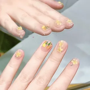 Handmade sheer nude press-on nails with 3D hand-painted yellow tulips and glitter