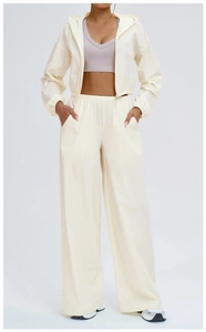 Detail of cream cropped hooded sun protection jacket and high-waist wide-leg pants set