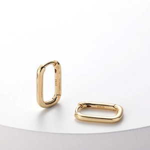 Macro detail of 18k gold S925 sterling silver stamp on rectangular hoop earrings