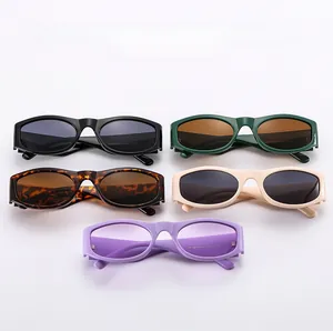 Multiple pairs of oval irregular sunglasses shown in black, green, and tortoiseshell frames