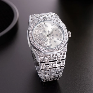 Close-up of luxury silver iced-out watch with crystal-encrusted octagonal bezel design