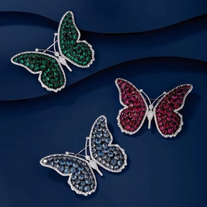 Macro detail of luxury butterfly brooch with colorful gemstones and pavé crystals