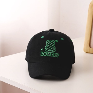 Close-up of kids black baseball cap with green bear embroidery and Lovely text detail