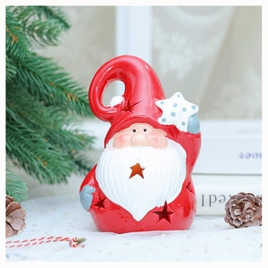 Close-up of a red Santa gnome candle holder with star cutouts on a festive table