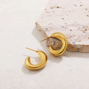 Detail of 18K gold-plated stainless steel chunky C-shape earrings with textured finish