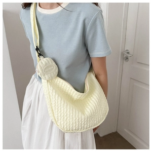 Detail of yellow pleated canvas shoulder bag with matching round fashion coin purse