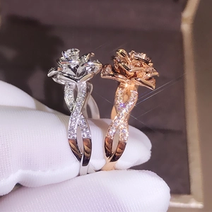 Exquisite 18K rose gold and silver flower rings with zircon accents on velvet