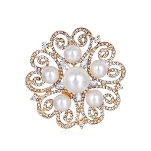 Close-up of golden frog king brooch with white pearls and sparkling crystal rhinestones