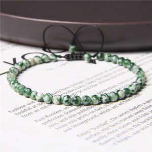 Close-up of 4mm green marble stone beads with adjustable black braided string cord