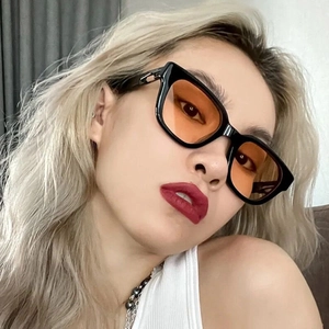 Chic black square frame sunglasses with amber lenses worn by a model in a 45-degree angle