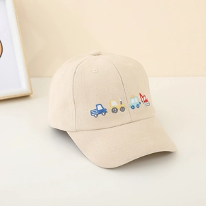 Detail of cartoon construction vehicle embroidery on beige cotton kids baseball cap
