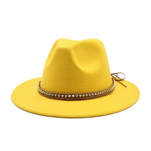 Detail of yellow wool fedora hat with woven decorative band and metallic beads