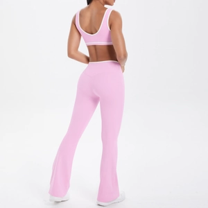 Detail of pink yoga set showing crisscross back sports bra and flared high-waisted pants