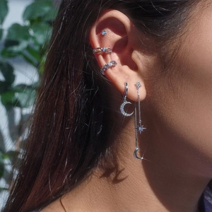 Detailed view of S925 silver celestial tassel earrings and moon star ear cuffs on ear