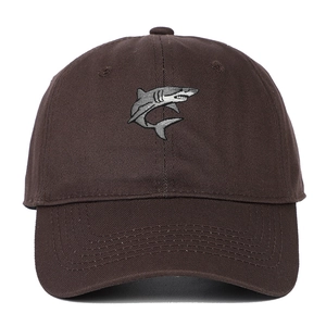 Detail of dark brown cotton baseball cap showing precise shark embroidery and curved brim