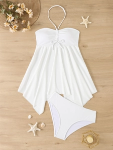 Flat lay of white halter neck tankini set with ruffled skirt hem and decorative bow