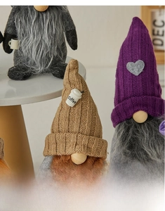 Close-up of knit coffee gnomes with long beards, hats and mini cup decorations