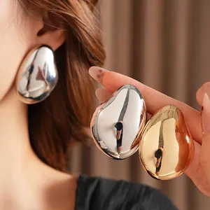 Polished metallic teardrop earrings in gold and silver, modern minimalist style design