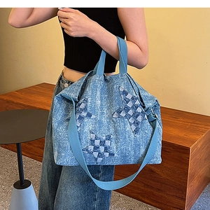 Detail of star patchwork pattern and woven strap on denim tote bag for women