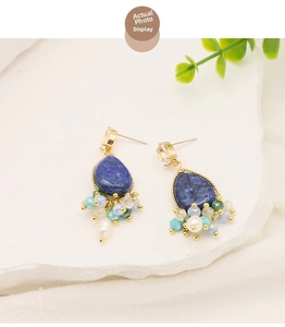 Detail of vintage bohemian teardrop lapis lazuli earrings with white pearls and gold accents