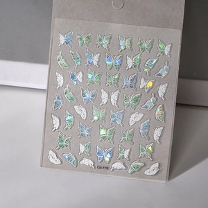Close-up of laser iridescent 3D butterfly nail stickers with holographic shell luster