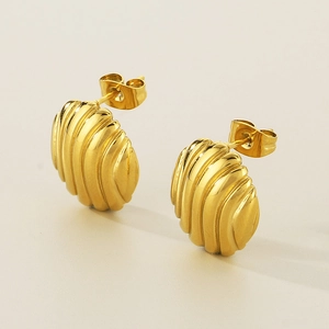 Macro detail of 18K gold plated croissant earrings with elegant vertical spiral textures