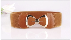 Detail of brown elastic waist belt with a golden metal bow buckle on a white surface