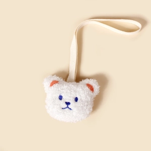 Attache-tétine ourson en peluche avec lanière en tissu crème pour l'apaisement de bébé