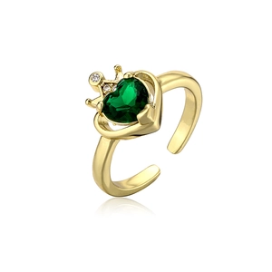 Close-up of crown heart ring with green gemstone and sparkling white crystals