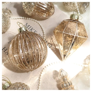 Detail of champagne gold Christmas ornaments with glitter stripes and vintage geometric textures