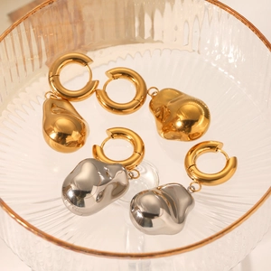 18K gold plated stainless steel hoop earrings with baroque lava pendants in a glass bowl