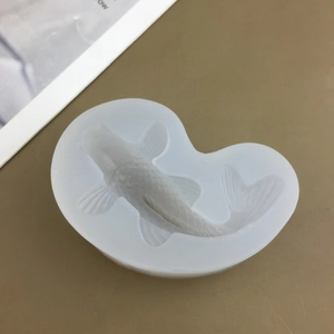 Detailed close-up of a white koi fish shaped silicone mold for cakes and chocolates