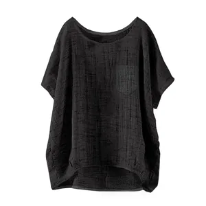 Detail of loose black linen top for women showing chest pocket and round neckline