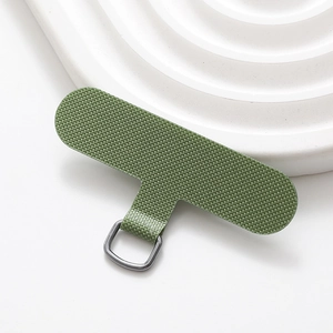 Macro view of green nylon phone tether tab with a durable grey metal D-ring attachment