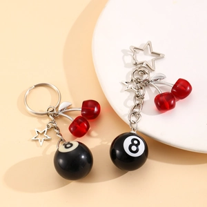 Detail of No. 8 pool ball keychain with red cherry beads and star shaped metal clip