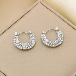 Macro shot of silver U-shaped earrings with shimmering pave-set micro zircons