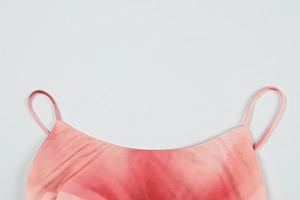 Detail of pink gradient dress showing thin shoulder straps and smooth silk texture