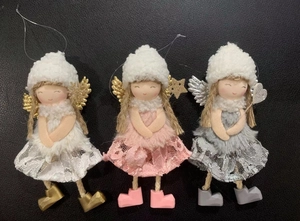 Detailed view of lace Christmas angel dolls in white, pink and grey with plush hats