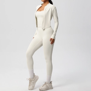Detailed view of 3-piece cream yoga set with zip jacket, tank top, and high-waist leggings
