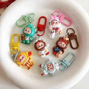 Close-up of seven cartoon character keychains in diverse costumes on a white plate