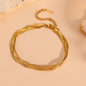 Detail view of a multi-strand gold stainless steel chain bracelet with lobster clasp
