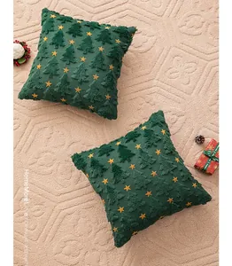 Detail of dark green plush Christmas tree pillow covers with embroidered yellow stars