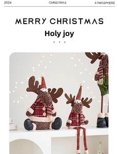 Detail of plush Christmas reindeer dolls in red and green plaid fabric on shelf