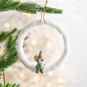 Christmas plush ring ornament with resin elf hanging on a decorated tree branch